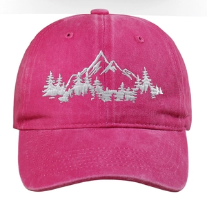 Macro shot of mountain forest white embroidery on a pink washed cotton baseball cap