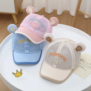 Detail of mesh toddler baseball caps with cute bear ears in pink, blue, and beige