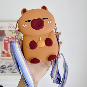 Cute Capybara silicone crossbody bag with colorful strap held in a home setting