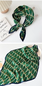 Detailed views of a green pleated silk scarf featuring golden shell patterns and navy edges