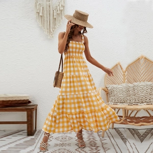 Detailed texture of yellow striped bohemian maxi dress with shirred bodice and thin straps