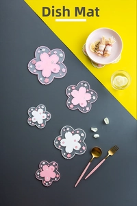 Detail of cherry blossom PVC placemats in pink and white with textured floral patterns