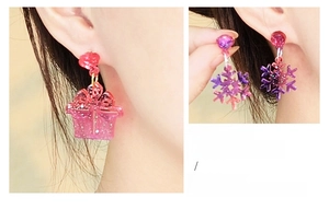 Detail of DIY Christmas resin earrings featuring pink gift box and purple snowflake designs