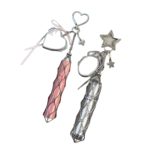 Y2K style lipstick holder keychain with metal mesh and pink silk bow on white background