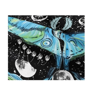 Detail of moth and moon phase tapestry fabric with star patterns and vibrant colors