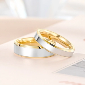 Close-up of dual-tone gold and silver titanium rings with polished beveled edges