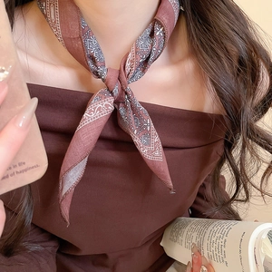 Detailed close-up of bohemian brown paisley print silk scarf necklace for women