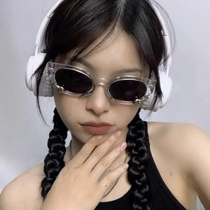 Close-up of cat-eye sunglasses with transparent frames and metal snake temple details