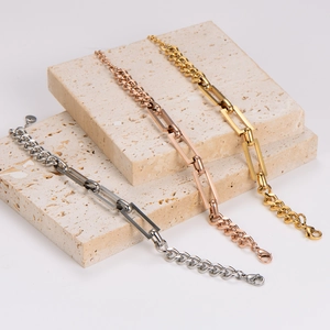 Modern stainless steel link bracelets in gold, silver and rose gold on a stone base