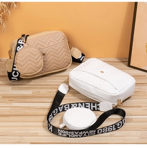 Detail of chevron quilted camera bags with wide patterned straps and mini coin pouches