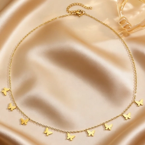 Golden stainless steel choker necklace with multiple butterfly charms on champagne silk