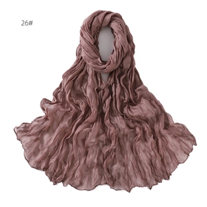 Detail of soft breathable deep pink cotton scarf with pleated texture and light material