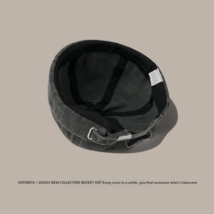 Detail of washed grey cotton docker hat showing the internal 100% cotton label and metal buckle