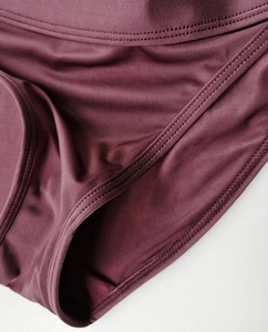 Detailed close-up of burgundy ice silk panties showing double-needle stitching and texture