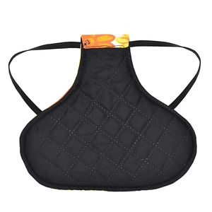 Detail view of black quilted poultry hen saddle with orange floral trim and elastic straps