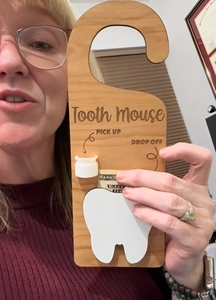 Detail of wooden tooth mouse hanger showing drop off pocket for tooth fairy money reward