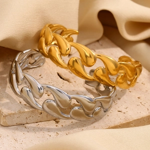 Minimalist 18K gold and silver teardrop chain bracelets on a stone background