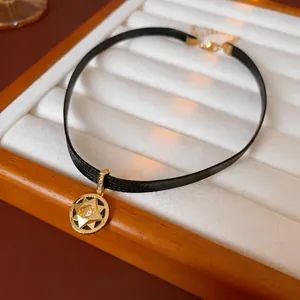 Elegant gold North Star zircon pendant on a black choker strap for a vintage luxury look