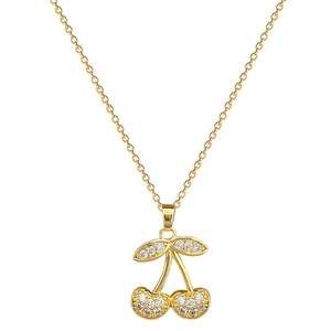 Elegant gold cherry pendant necklace with pavé cubic zirconia on a white background