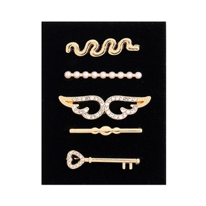 Detailed macro view of 5-piece golden alloy watch band decorative rings with rhinestones
