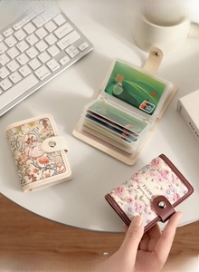 Detail view of vintage floral card holder interior with multiple PVC slots and metal button