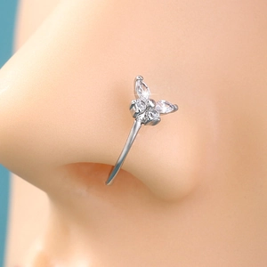 Close-up of a silver butterfly nose ring with sparkling cubic zirconia on a model