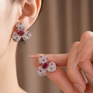 Vintage zircon flower earrings with red gems and pavé white stones in silver-tone metal