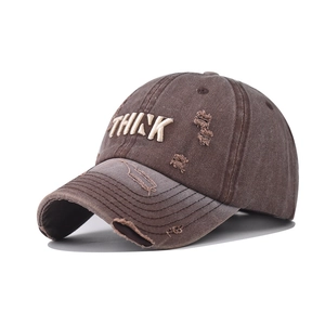 Detailed close-up of 3D THINK embroidery on distressed washed cotton baseball cap