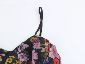 Detail view of sweet floral organza dress showing slim shoulder straps and bodice design