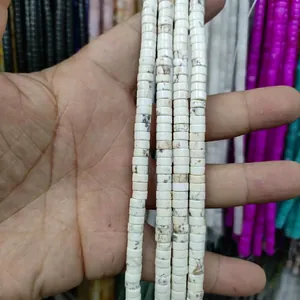 Macro shot of white turquoise disc beads showing natural marble textures for DIY jewelry