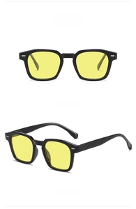 Vista frontal y lateral de gafas de sol cuadradas negras con lentes amarillas