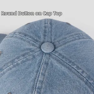 Macro shot of the round top button and twill denim stitching detail on baseball cap