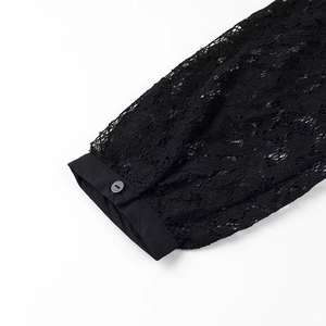 Close-up of black lace fabric sleeve with button detail on woven cuffs for women shirt