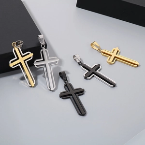 Macro display of hollow cross pendants in gold, silver and black stainless steel