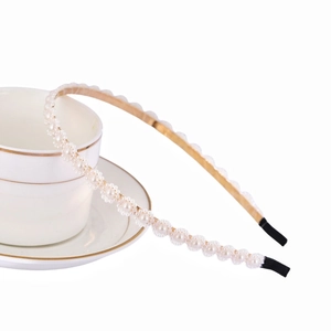 Elegant thin gold metal headband featuring white pearls and crystal flower accents