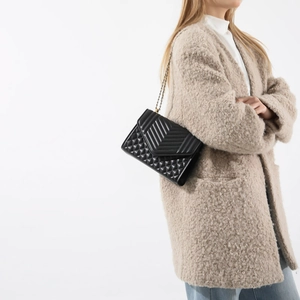 Elegant black quilted shoulder bag with gold chain strap and dual-pattern leather texture