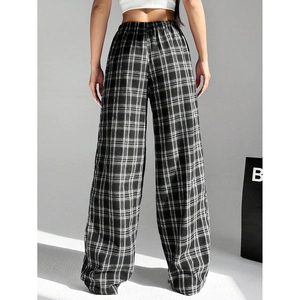 Detail of high waist elastic waistband and black white checkered pattern on wide leg trousers