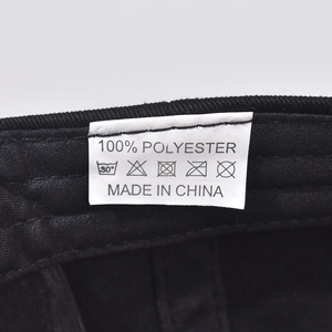 Macro view of inner polyester lining with care label for black baseball cap