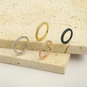 Macro shot of steel hoop earrings in silver, gold, rose gold and black with pavé crystals