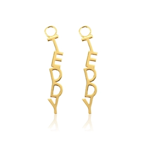 Detail of gold Teddy letter drop earrings with polished finish and vertical typography