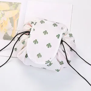 Detail of drawstring makeup bag featuring cactus pattern and velcro closure