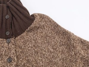 Close-up of brown chunky knit sweater showing rib-knit collar and button placket detail