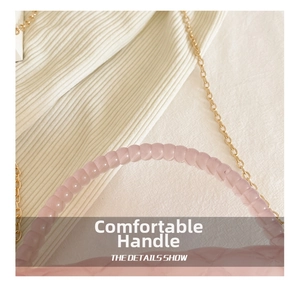 Detail of pink beaded handle and gold chain strap on quilted jelly crossbody bag