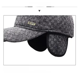 Close-up of grey plaid winter baseball cap with plush fur lining and ear protection