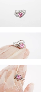 Detail of silver open ring featuring a pink heart-shaped zircon and lace glove presentation