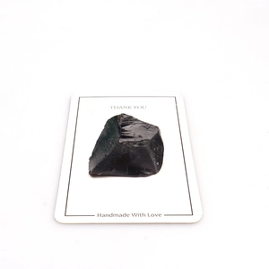 Detail of raw black obsidian ore specimen on a Thank You card for mineral collections