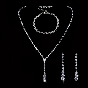 Macro view of silver bridal jewelry set featuring sparkling rhinestone necklace and earrings