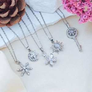 Elegant silver pendant necklace set with snowflake, star moon, and key charms in cubic zirconia