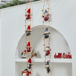 Detail of Christmas Santa climbing ladder ornaments with red and grey fabric dolls