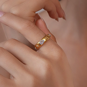 Detail view of a gold-plated vintage ring with blue zircon stones on a model's hand